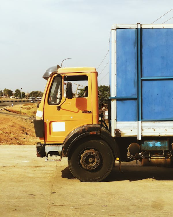 An orange and blue dumpster 