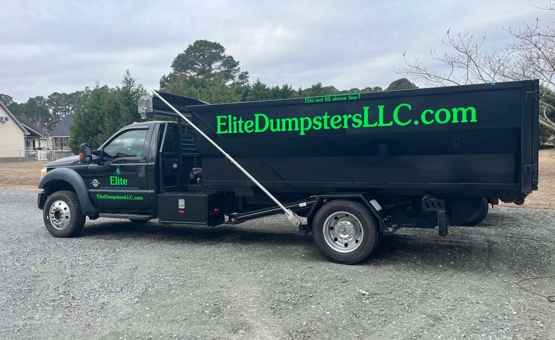 Waste disposal truck with Elite Dumpsters and Disposal LLC name displayed on the back storage area