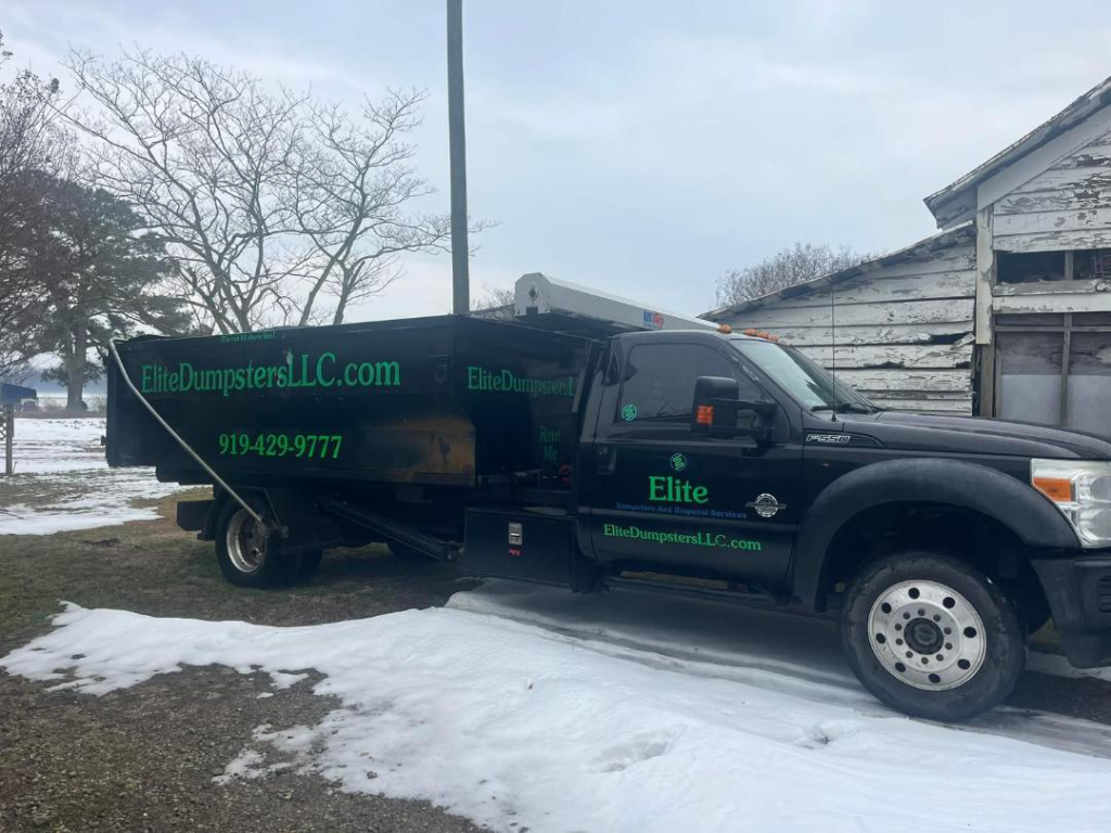 Snow beneath a dumpster truck