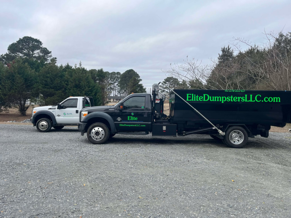 Two dumpster trucks on the street