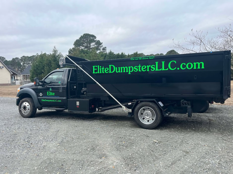 A large dumpster truck with green logo