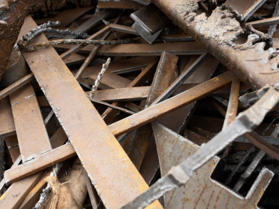 Home renovation debris including wood, drywall, fixtures, and construction materials awaiting removal.